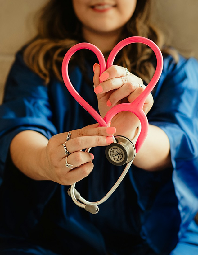Doctor holding heart-shaped stethoscope